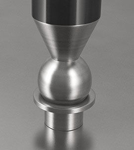 A close-up of a dapping tool being used to shape a metal piece.